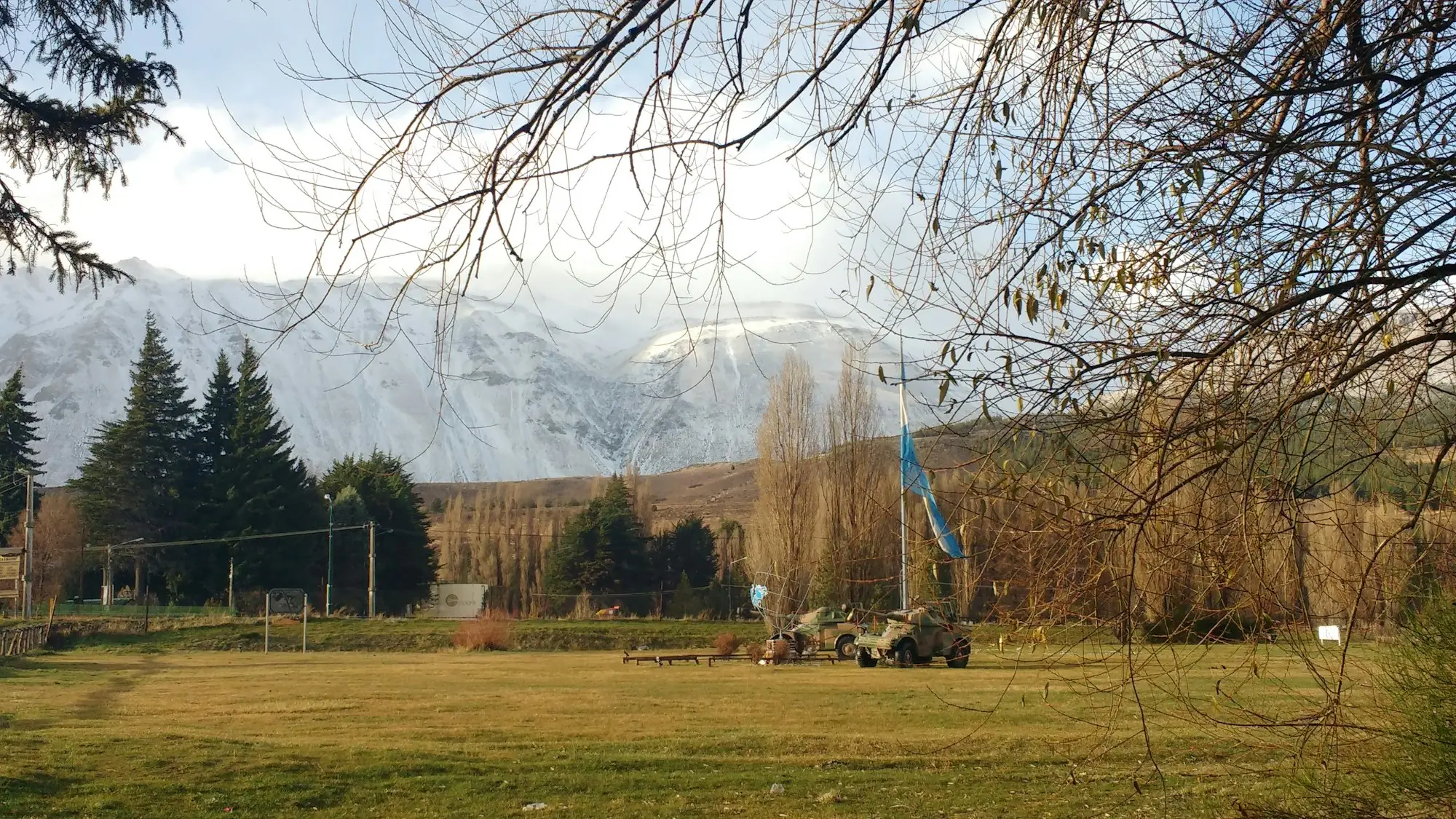 Yellow excavator parked in an equipment yard on the Canterbury Plains